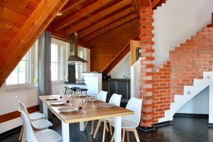 a dining room with a table and a brick wall at Fewo Feldblick in Merkendorf