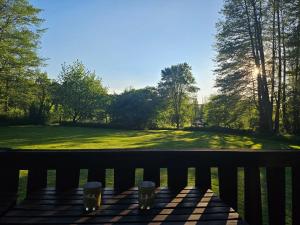 a view from a porch with two glasses of beer at Weiherhüttla in Untersteinach +12 photos