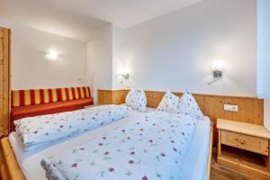 a bedroom with a large bed with blue sheets at Maurerhof Morgenrot in Maranza