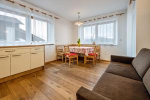 a living room with a couch and a table at Maurerhof Morgenrot in Maranza +12 photos