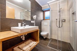 a bathroom with a sink and a shower at Maurerhof Morgenrot in Maranza