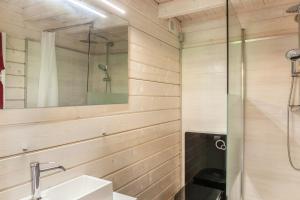 a bathroom with a glass shower and a sink at Sundowner Cabin in Oberammergau +21 photos