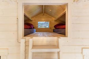 a room in a tiny house with two beds at Sundowner Cabin in Oberammergau