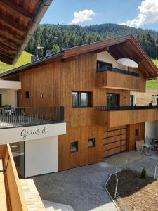 a large house with a porch and a balcony at Ladinser Hof Sternenhimmel in Castelrotto