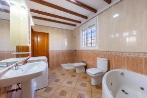 a bathroom with a sink and a toilet and a tub at La Tierra in Níjar +14 photos