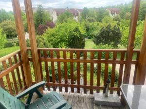 a deck with a chair and a table and a view at Im schönen Garten in Haldensleben +4 photos