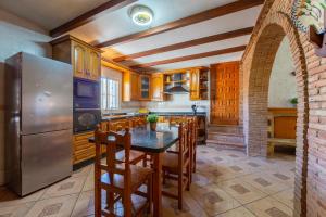 a kitchen with a table and a refrigerator at La Tierra in Níjar