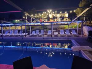a pool at night with chairs and a bar at Oasi Torre Di Mastro, Conversano in Conversano