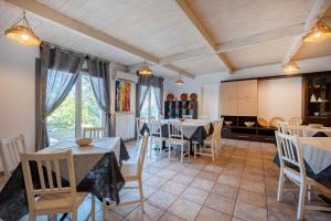 a dining room with tables and chairs and a kitchen at Oasi Torre Di Mastro, Conversano in Conversano