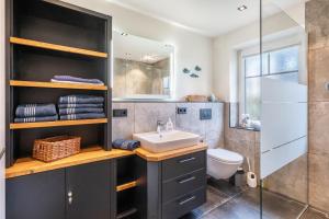 a bathroom with a sink and a shower at Kleine Auszeit in Dagebüll +23 photos