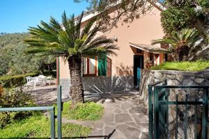 a house with a palm tree in front of it at Villa Del Sole in Bonassola