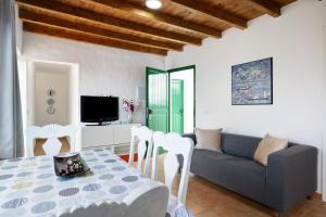a living room with a couch and a table and chairs at San roque in Tinajo