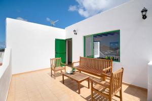 a patio with two benches and a table at San roque in Tinajo