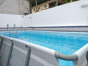 a swimming pool on a white fence at Casa Cimo D'Aldeia in Vila Cova de Perrinho