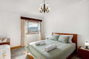 a bedroom with a bed with two pillows on it at Casa Cimo D'Aldeia in Vila Cova de Perrinho +29 photos