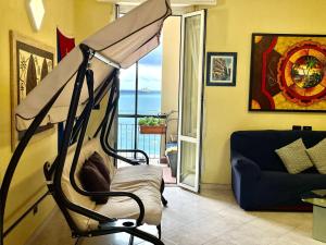 a room with a hammock in front of a living room at Casa Conchiglia in Vado Ligure