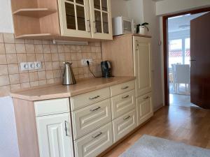 a kitchen with white cabinets and a counter top at Ferienhaus Rübeland in Neuwerk +29 photos