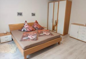 a bedroom with a bed with three pillows on it at Ferienhaus Rübeland in Neuwerk