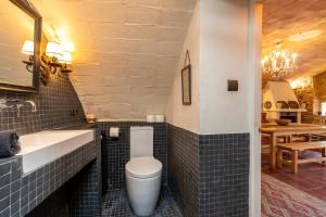 a bathroom with a toilet and a sink and a table at Casa rural siglo xviii in Pals +23 photos