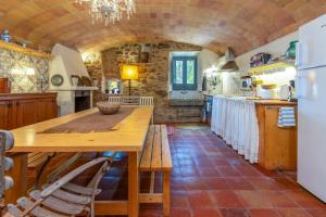 a kitchen with a wooden table in a room at Casa rural siglo xviii in Pals