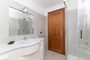 a bathroom with a sink and a shower and a mirror at San Teodoro Villa Ambra Costa Caddu in San Teodoro +25 photos