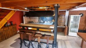 a kitchen with a stove and a table in a room at Casa quincho en plottier in Plottier