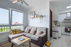 a living room with a couch and a table at Primera línea de playa Cabo Cruz in Boiro
