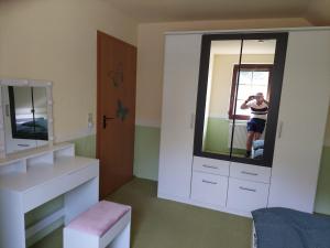 a person taking a picture in a bathroom mirror at Haus schöne Aussicht bei Chemnitz in Chemnitz
