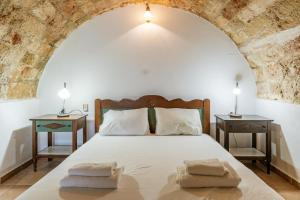 a bedroom with a large bed with two night stands at Casa Tradizionale Monemvasia in Monemvasia
