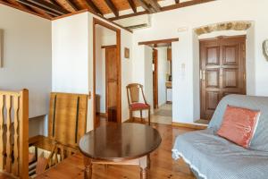 a living room with a table and a couch at Casa Tradizionale Monemvasia in Monemvasia +13 photos