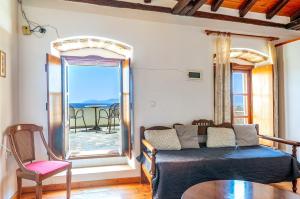 a room with a bed and a table and a window at Casa Tradizionale Monemvasia in Monemvasia