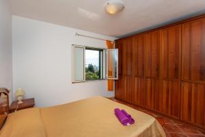 a bedroom with a bed with a purple phone on it at Appartamento Paguro in Cala Liberotto