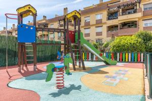 a playground in front of a building with a slide at Ágora Alhambra in Atarfe