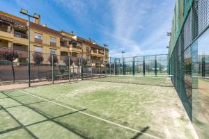 a tennis court in front of a building at Ágora Alhambra in Atarfe