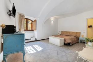a bedroom with a bed and a dresser in a room at Al Castello Residenza D'Epoca in Pietra Ligure