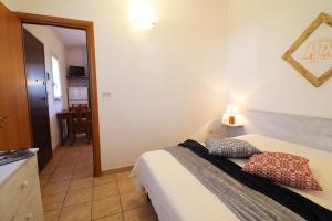 a bedroom with a bed and a mirror at Bungalow Sultanina in Otranto +37 photos