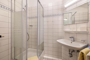 a white bathroom with a shower and a sink at Fewo Brünnstein - Zimmer 50 in Oberaudorf +25 photos