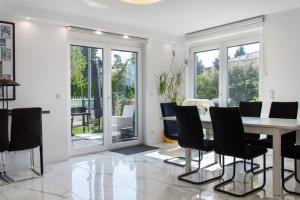 a dining room with a table and chairs at Luxusvilla Neubau 2 in Oberasbach