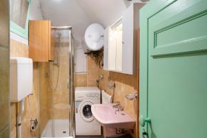 a bathroom with a sink and a washing machine at Casa Gianni in Vallebona +12 photos
