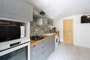 a kitchen with a sink and a stove at Charmant appartement 3 etoiles in Courchevel