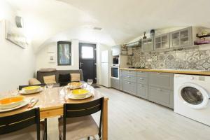a kitchen and living room with a table and a dining room at Charmant appartement 3 etoiles in Courchevel