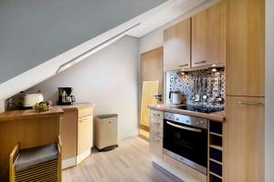 a kitchen with a sink and a stove at Ferienwohnung Das Nest in Schiltach