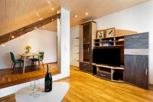 a living room with a wine bottle on a table at Ferienwohnung Das Nest in Schiltach