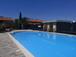 a large blue swimming pool next to a building at Residence Valle Fiorita in Piombino