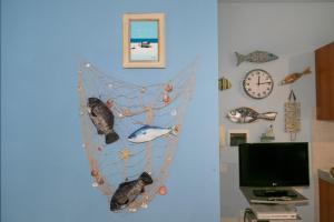 a blue wall with a fish decoration on it at Residence Valle Fiorita in Piombino