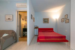 a bedroom with a red bed in a room at Residence Valle Fiorita in Piombino +13 photos