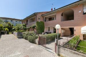 a brick building with a gate in front of it at Residence Valle Fiorita in Piombino