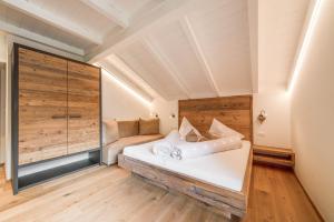 a bedroom with a large white bed in a room at Sonnleiten Sterngucker 7 in Collepietra +31 photos