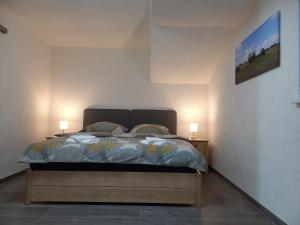 a bedroom with a bed with two lamps on both sides at Bauernhof Schäfer in Mühlacker