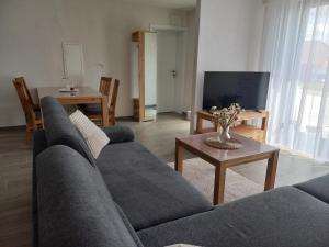 a living room with a couch and a table at Bauernhof Schäfer in Mühlacker